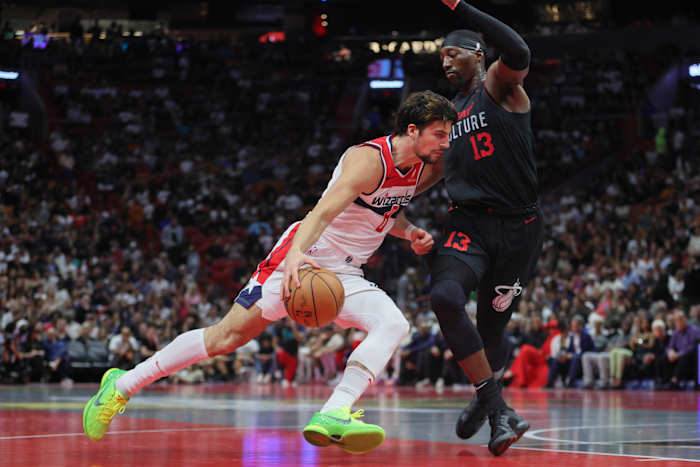 Washington Wizards forward Deni Avdija (8) drives to the basket against Miami Heat center Bam Adebayo (13) during the second quarter at Kaseya Center.